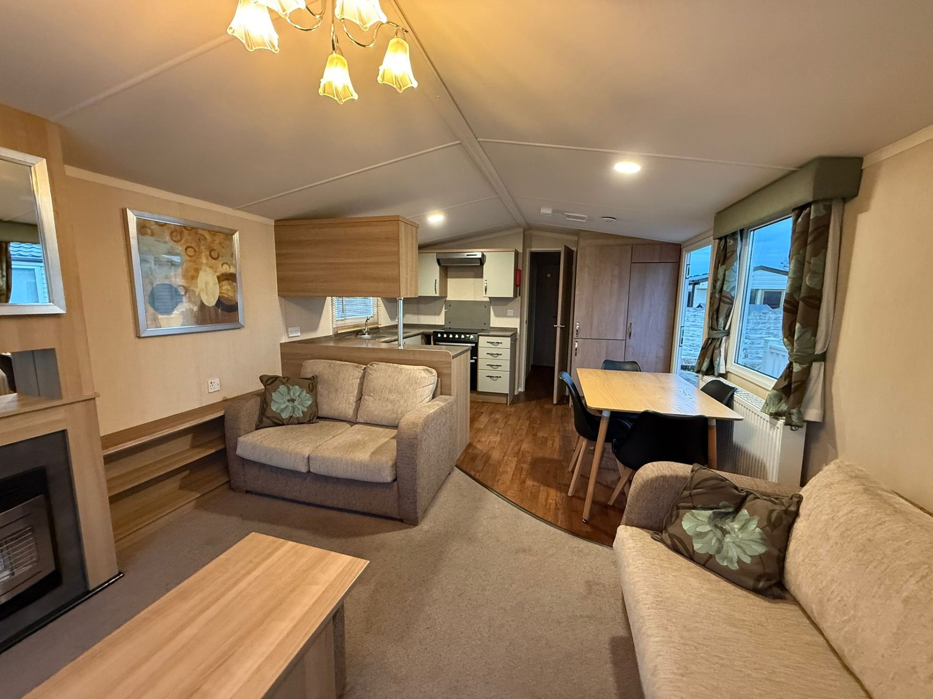 Spacious lounge with sofas, feature fire and dining area